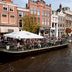 Golden Tulip Leiden Centre hotel near Leiden canal with waterside terrace and boats