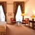Pousada Palácio de Queluz guest room with twin beds, tall draped windows, and seating area in Queluz