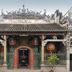 Funny Guesthouse in Ho Chi Minh City, ornate traditional facade with tiled roof and decorative carvings