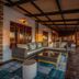Gondwana Etosha Safari Lodge in Okaukuejo: covered terrace with seating and sunset views