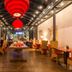 Tides Boutique Hotel in Norden dining room with red lanterns, high ceiling, and set tables