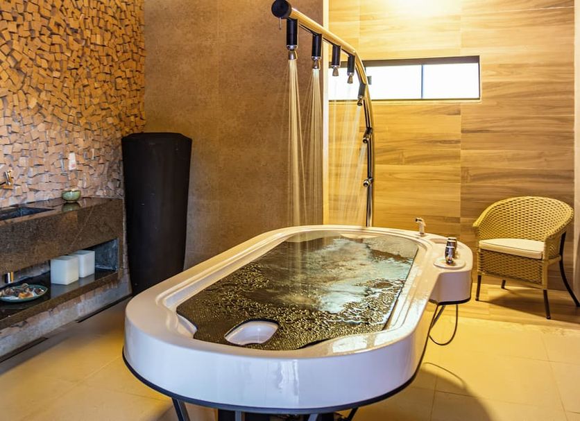 Rio Quente Resorts - Hotel Luupi spa room with soaking tub and shower in Rio Quente