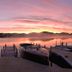 Lake Placid Lodge in Lake Placid with dock and boats on a calm lake at sunset