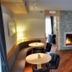Hotel Maribel in Madonna di Campiglio lounge with curved seating, bar stools and a stone fireplace