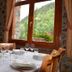 Hostal la Font in Os de Civís dining room with set table and mountain-view window