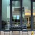BB Boutique Mansion in Bangkok patio seating with glass doors and a small golden statue
