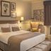 De Vere Latimer Estate guest room in Chesham with king bed, window seat, desk and framed wall art