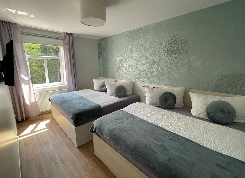 Penzion Jasmin in Liberec twin bedroom with two beds and window view