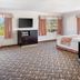 Glendale Hotel in Glendale room with two windows, desk, TV, sofa, and bed