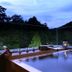 Sumiya Kiho-An Ryokan in Kameoka with an outdoor hot tub overlooking a wooded hillside at dusk