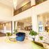Hotel Diana Woolloongabba lobby in Brisbane with colorful seating, high ceiling, and mezzanine railing