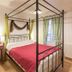 Logis Auberge La Cremaillere in Villandraut, four-poster bed in a cozy guest room with desk and window