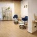 Rina Vista, Braşov lobby with blue chairs, round tables and dried floral decor