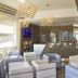 Hotel Atilius Adults Only lobby seating area with lounge chairs, reception desk, and bar in Limone sul Garda