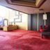 Benakutai Hotel and Apartemen in Balikpapan lounge with red carpet and red chairs