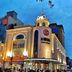 Hanting Hotel Harbin Train Station Branch exterior in Harbin at dusk, with illuminated corner tower and storefronts