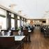 Dining room at Good Morning+ Göteborg City in Gothenburg with tables set for guests and wood floors
