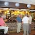 Green Acre Motel in Bridgend bar area with guests standing at the counter and one seated at the bar