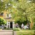 Hotell Björkhaga in Mullsjö, yellow hotel exterior with garden terrace and guests outdoors
