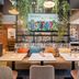 Ibis Styles Wien City lobby seating area with colorful wall art and hanging plants in Vienna
