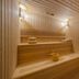 Riviera Rayhaan by Rotana Doha sauna with wooden benches and wall sconces