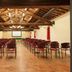 La Certosa di Pontignano meeting room in Castelnuovo Berardenga with rows of chairs and exposed beams