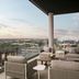 Loews Arlington Hotel in Arlington balcony lounge with city views and cushioned seating