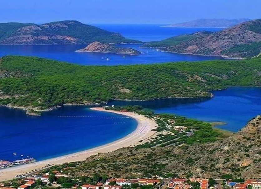 Tayfun Apart in Ölüdeniz with panoramic view of a curved beach, blue lagoon, and surrounding hills