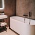 Hotel Noreg Ålesund bathroom with freestanding tub and lit mirror