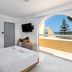 Olive Garden Hotel in Lardos room with arched balcony view of the sea and trees