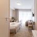 Osrodek Wypoczynkowy Wiga guest room in Kolobrzeg with twin beds, desk, TV and balcony doors