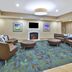 Candlewood Suites Morgantown-Univ West Virginia lobby lounge with fireplace, TV, and seating area