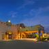Best Western Gold Canyon Inn & Suites exterior at dusk in Gold Canyon with warm-lit entrance