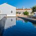 Herdade da Malhadinha Nova, Beja: outdoor pool with lounge chairs and white villa reflection