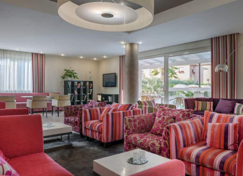 Hotel Nazionale in Desenzano del Garda lounge with colorful striped sofas and large windows