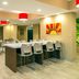 Microtel Inn & Suites by Wyndham Red Deer lobby with bar seating and red pendant lights