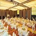 Shenyang Neu International Hotel in Shenyang banquet hall set with round tables and white chair covers