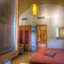 Hotel Zeus in Pompei guest room with arched ceiling, twin beds, and warm lighting