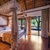 Ivory Tree Game Lodge in Pilanesberg, canopy bed suite with patio doors to pool view