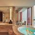 Zhehai Hotel Ningbo bathroom with soaking tub, vanity, and city-view window in Ningbo