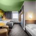 B&B Hotel Baden-Airpark in Rheinmunster guest room with two beds, table seating, and window