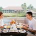 The Suites At Mount Malarayat in Lipa City: couple dining on a terrace with lake and garden views