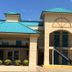 Americas Best Value Inn Kosciusko exterior with teal roofs, covered entrance, and balcony