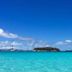 Green Roof Inn in Carriacou overlooks a turquoise bay with sailboats and a small island under a blue sky