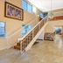 Days Inn by Wyndham San Antonio Airport lobby with staircase, high windows, chandelier and seating area in San Antonio