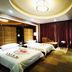 Huangtai International Hotel Jinan room with two beds, chaise lounge, desk and curtains