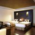 The Heritage Sathorn Suite Hotel Bangkok guest room with two beds and sofa seating