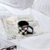 Dye House Providence guest bed with newspaper and coffee mug on white bedding