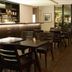 Libertad Hotel Buenos Aires bar and dining area with tables, chairs, and floor-to-ceiling windows in Buenos Aires