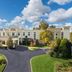 Hampton Inn & Suites Opelika-I-85-Auburn Area hotel exterior with landscaped driveway in Opelika